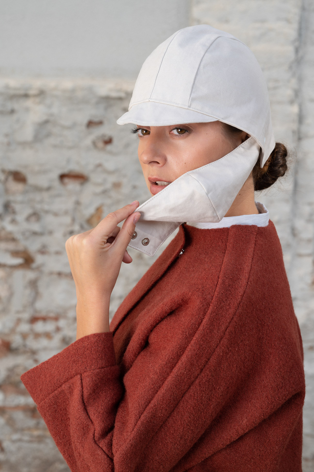 Primer plano de la modelo con gorro blanco y jersey granate